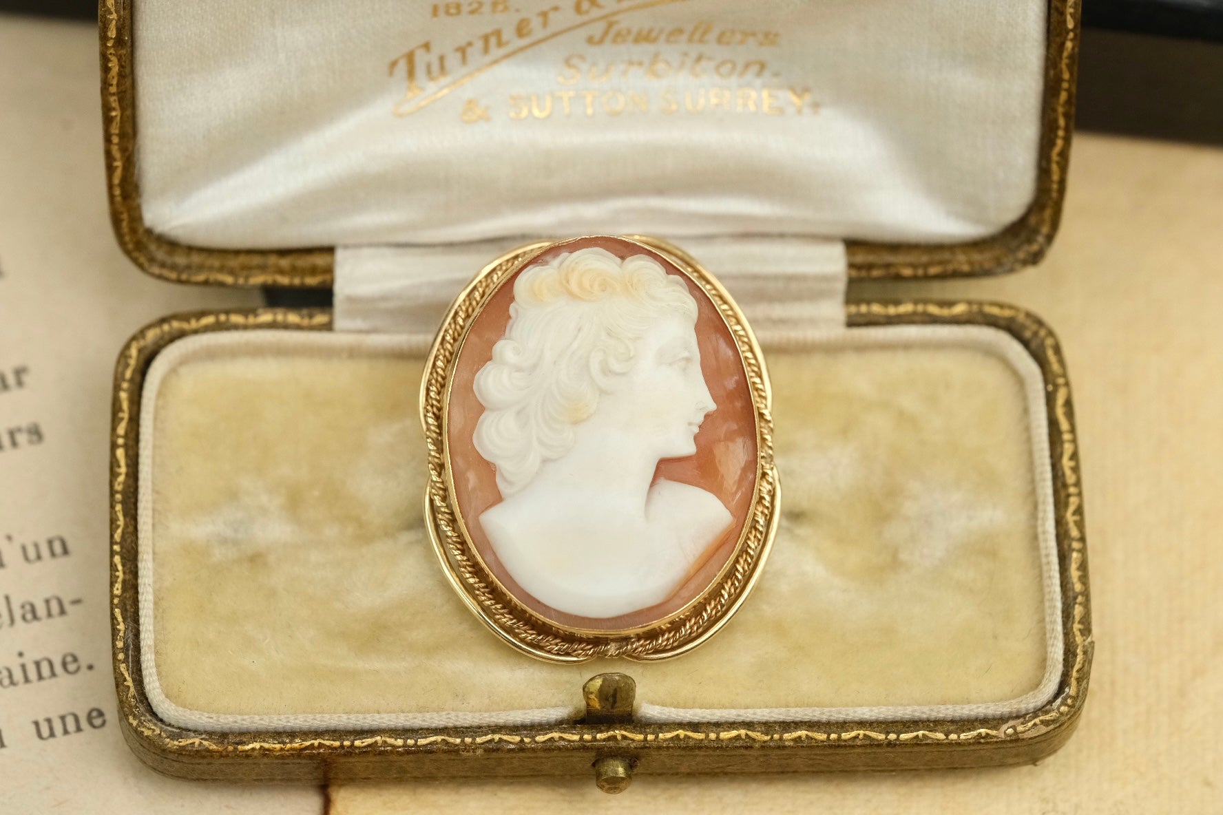 Front view of 14K gold carved cameo brooch pendant