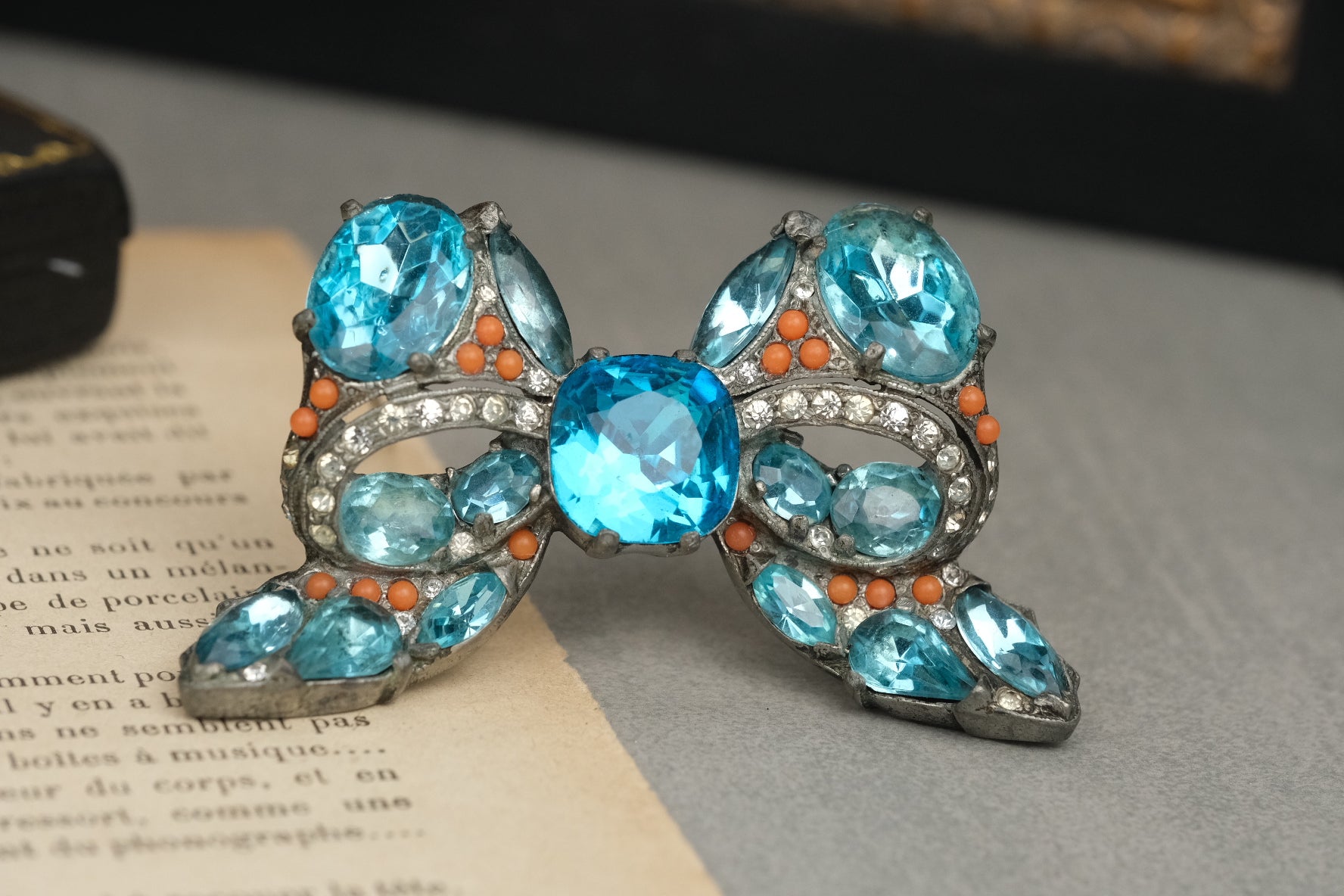 Signed Eisenberg Original blue and coral-color bow brooch front view