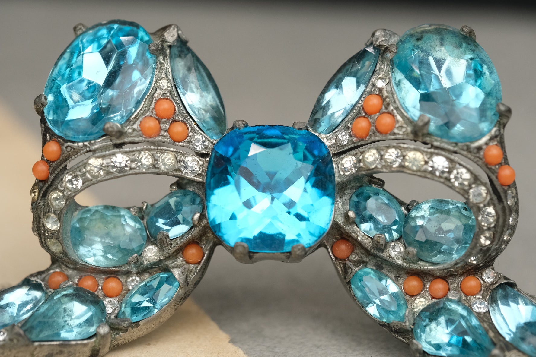 Detailed view of the center blue stone and rhinestone bow setting