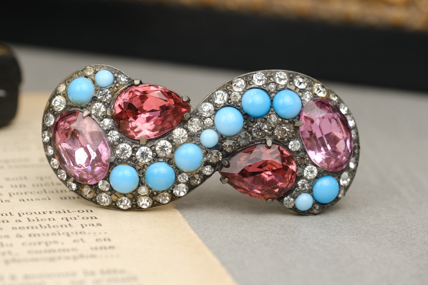 Eisenberg Original infinity brooch with two-tone pink stones and turquoise-color cabochons