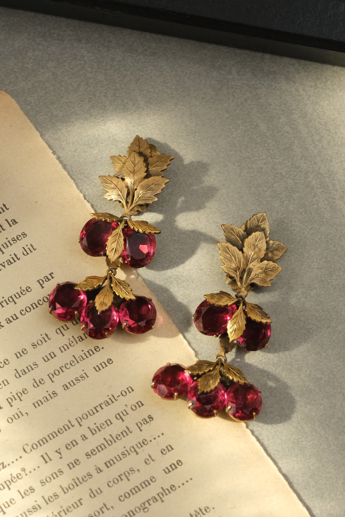 Joseff of Hollywood ruby glass fruit and gold leaf long drop clip-on earrings, full view