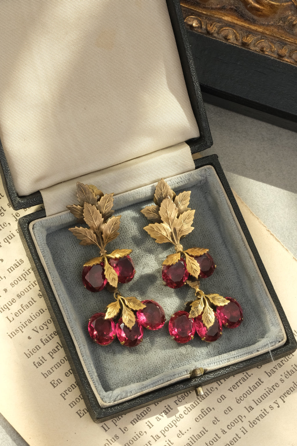 Joseff of Hollywood fruit and leaf clip-on earrings displayed in a vintage jewelry box