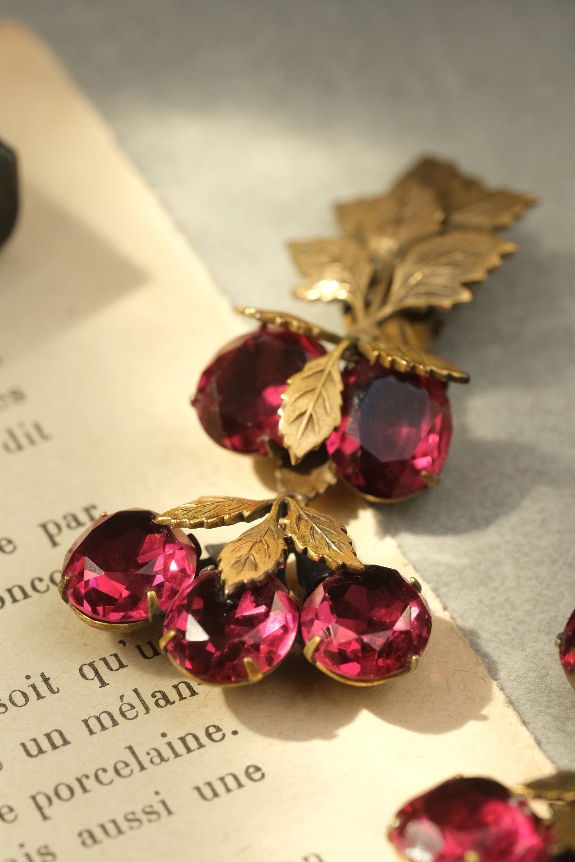 Faceted ruby glass fruit cluster detail on vintage clip-on earrings