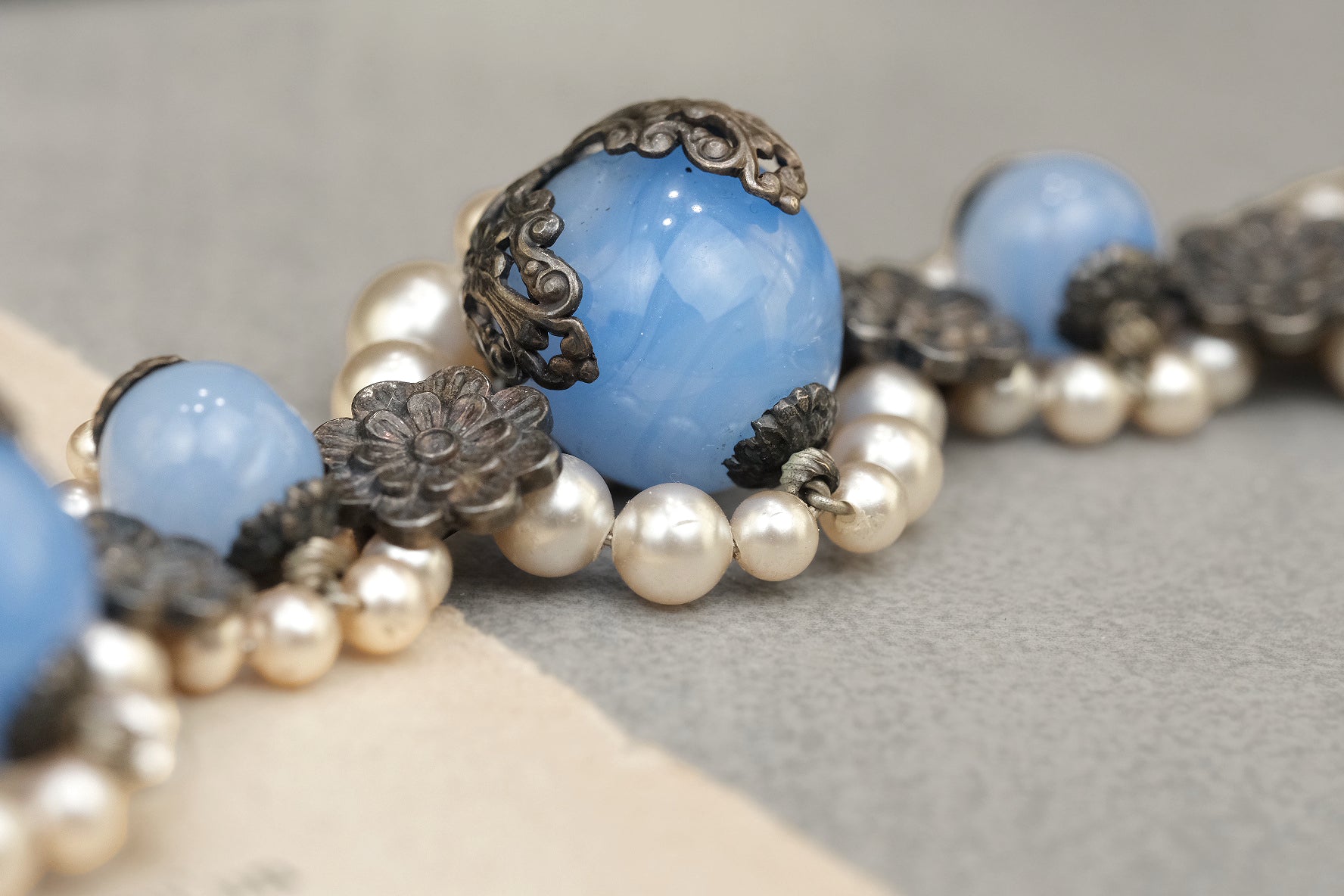 Blue glass bead and pearl cluster necklace close-up