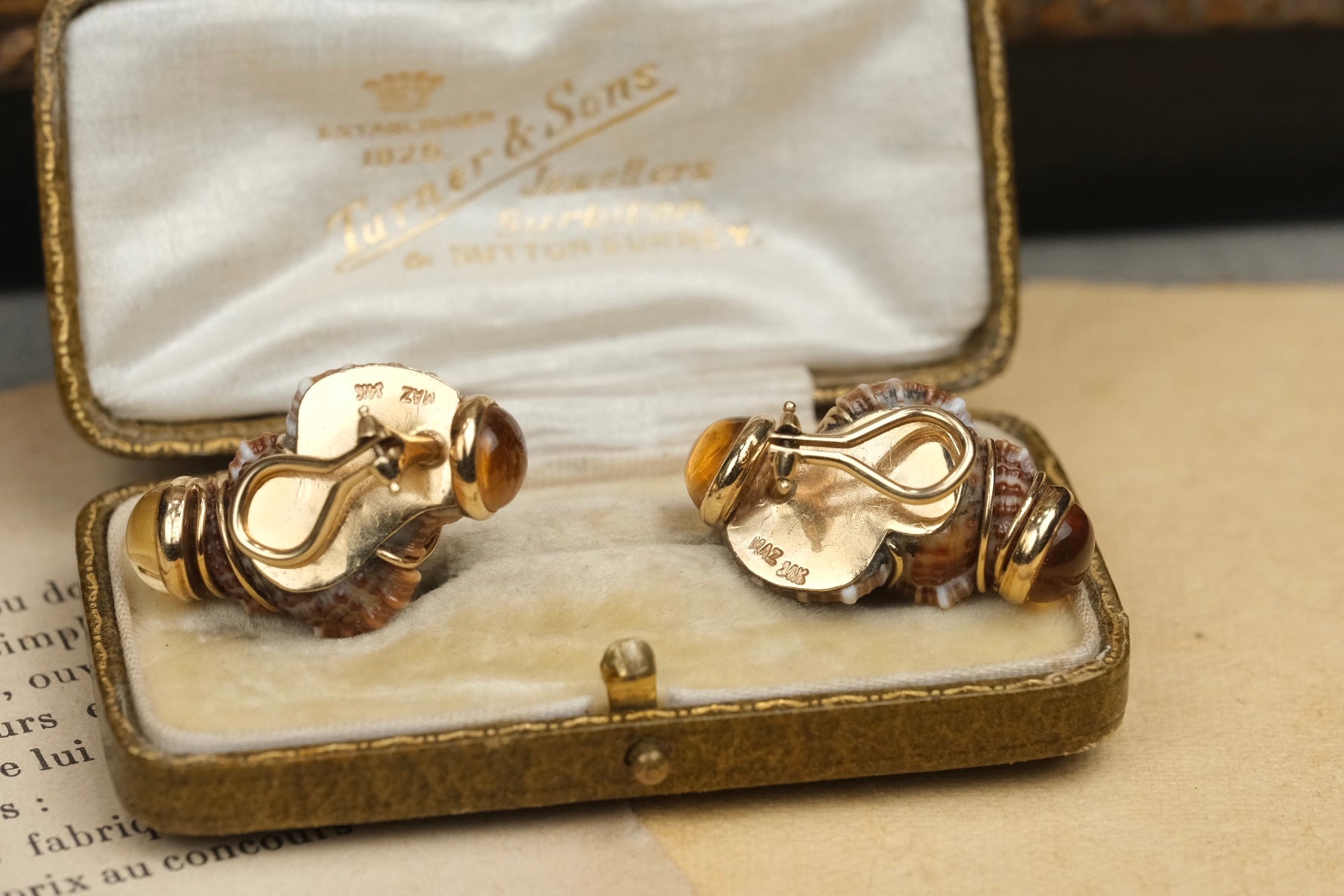 MAZ marked 14K gold clip fittings on Turbo Shell earrings