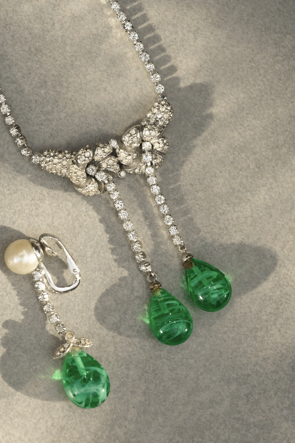 Rhinestone floral necklace with green swirled glass drop details
