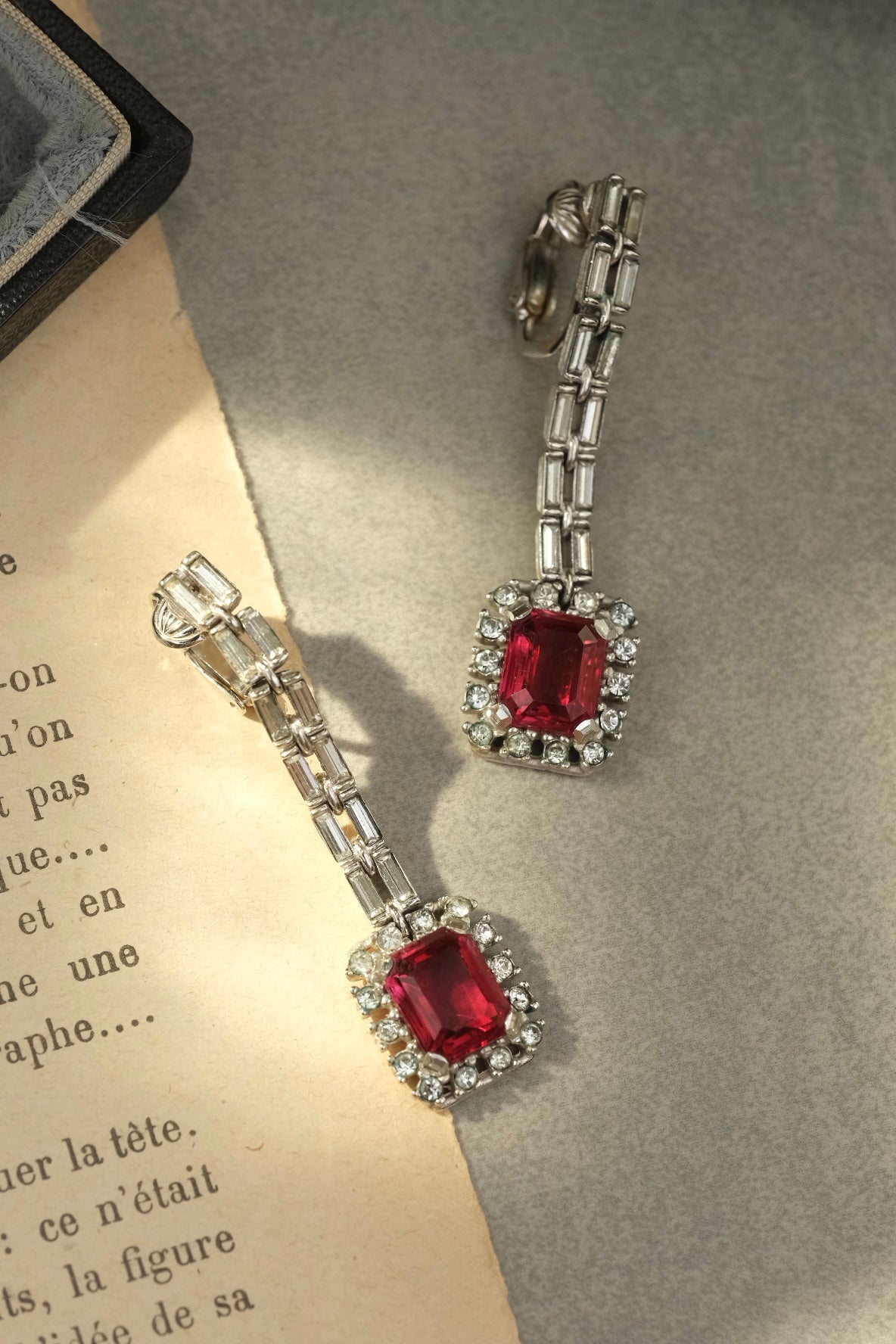Ciner emerald-cut red glass and rhinestone long drop clip-on earrings in natural light