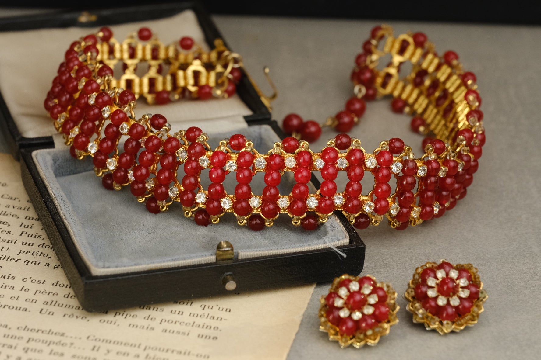 Unsigned William DeLillo red glass necklace and floral clip-on earrings set