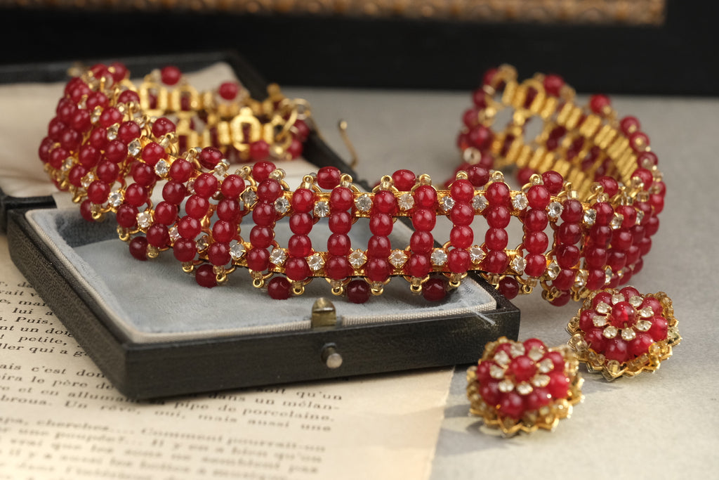 Rare red glass necklace and matching floral clip-on earrings, full composition