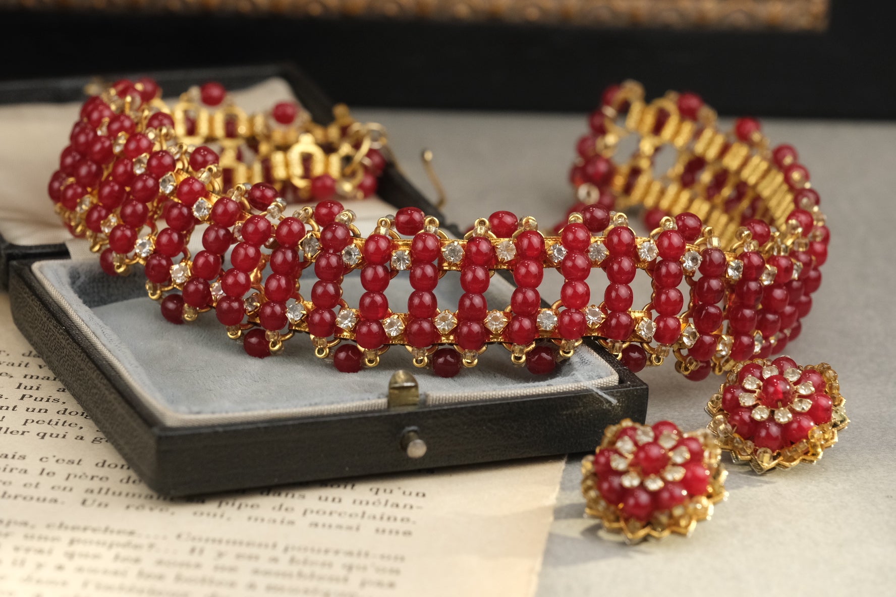 Rare red glass necklace and matching floral clip-on earrings, full composition