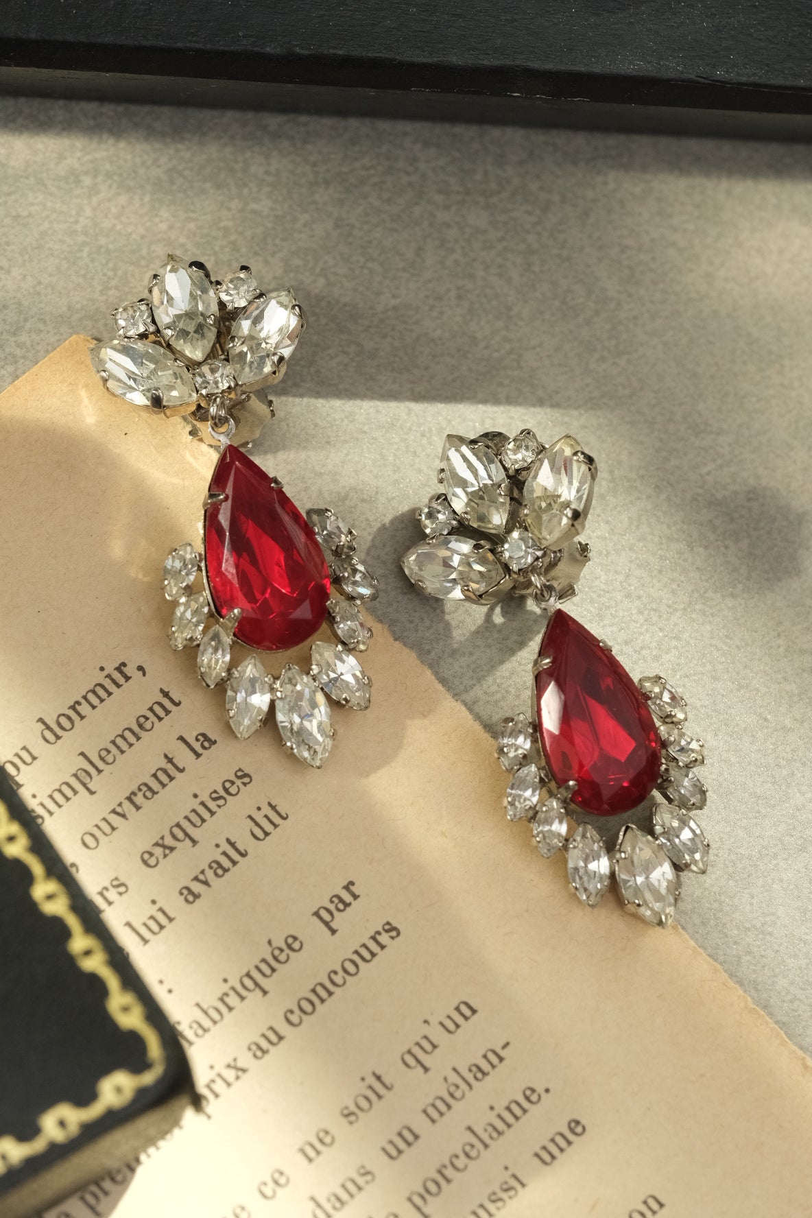 Western Germany red teardrop glass and clear crystal clip-on earrings in natural light