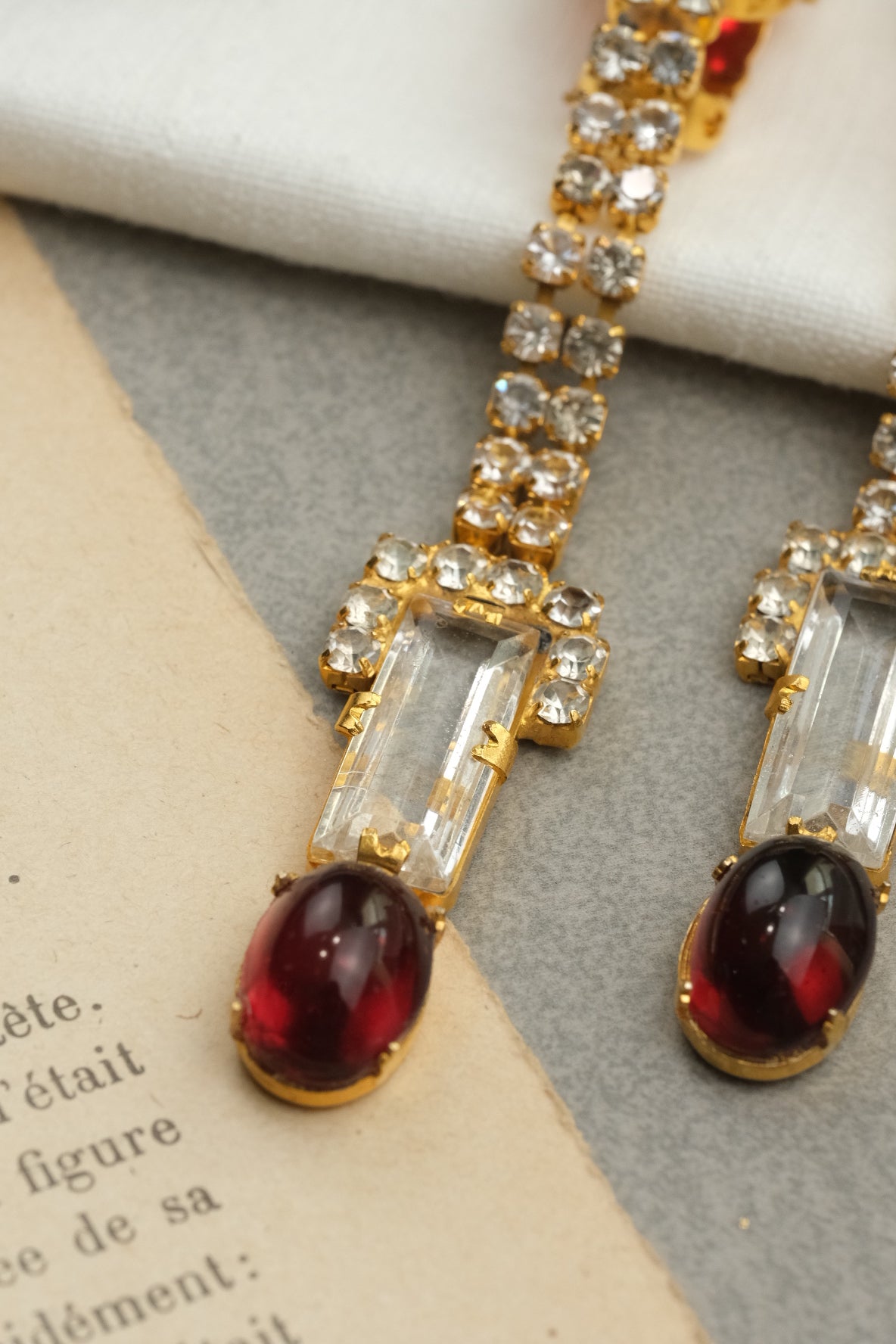 Clear rectangular glass and ruby cabochon drop detail on William DeLillo earrings